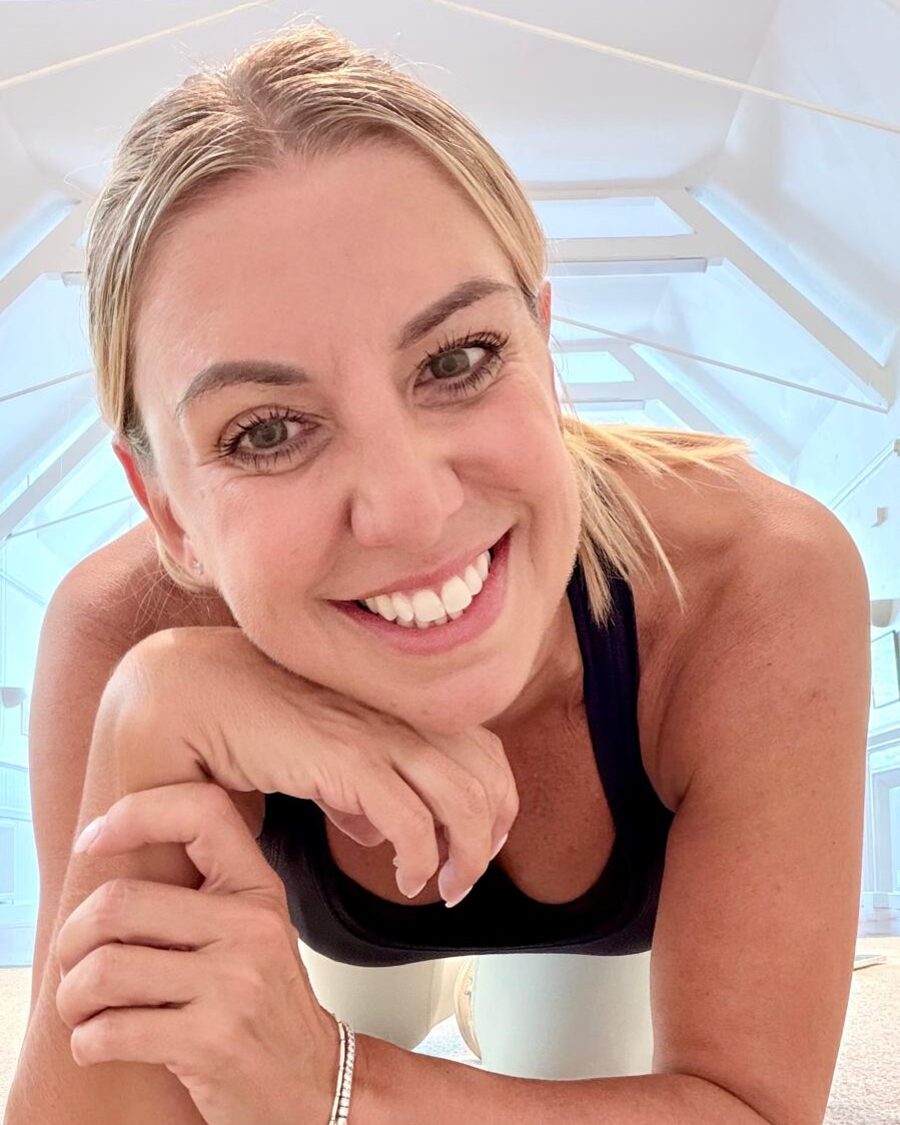 Nicola Kirby smiling on her exercise mat